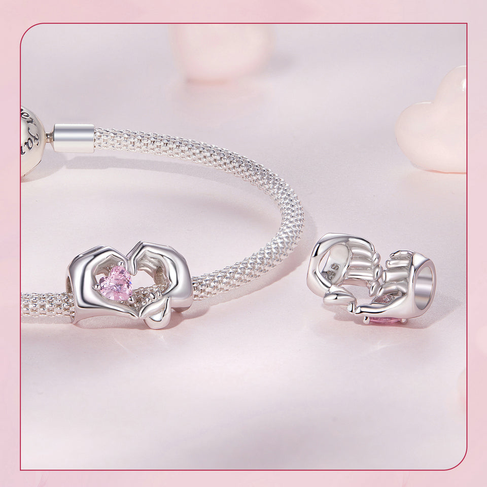 Silver charm with mother and child hands forming heart holding pink crystal bead for bracelet