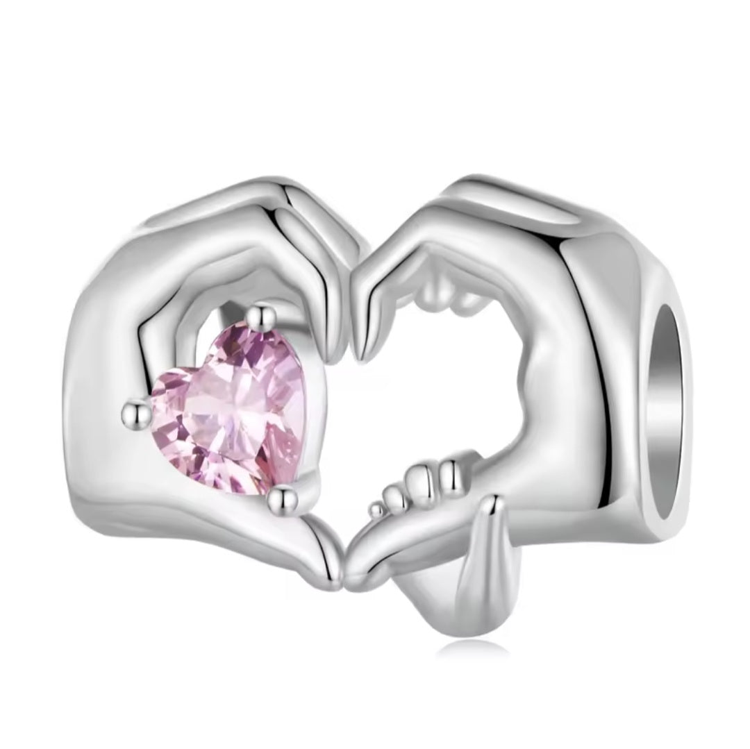 Silver charm with mother and child hands forming heart holding pink crystal bead for bracelet
