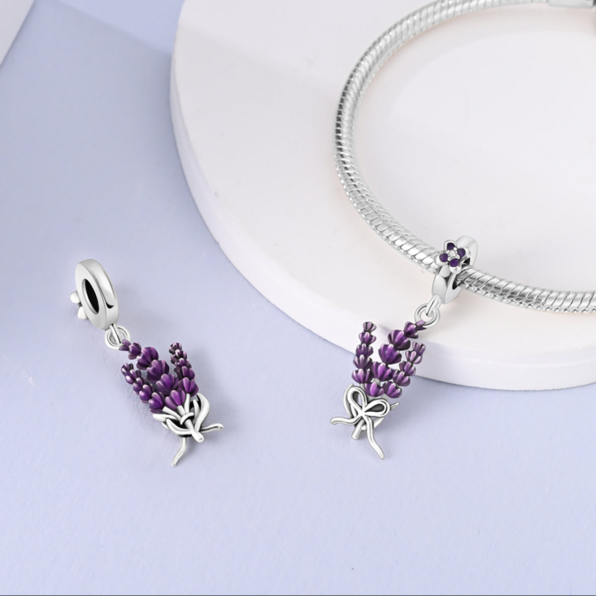 Sterling silver lavender flower dangle charm with purple enamel petals and crystal detail.