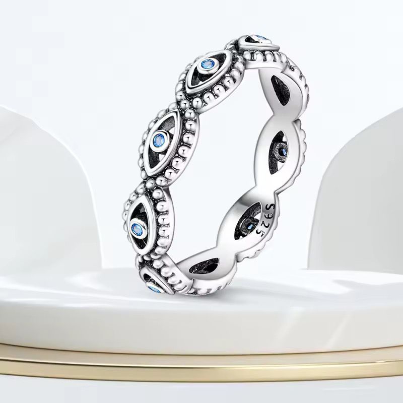 Sterling silver evil eye ring with blue crystal accents and beaded detailing