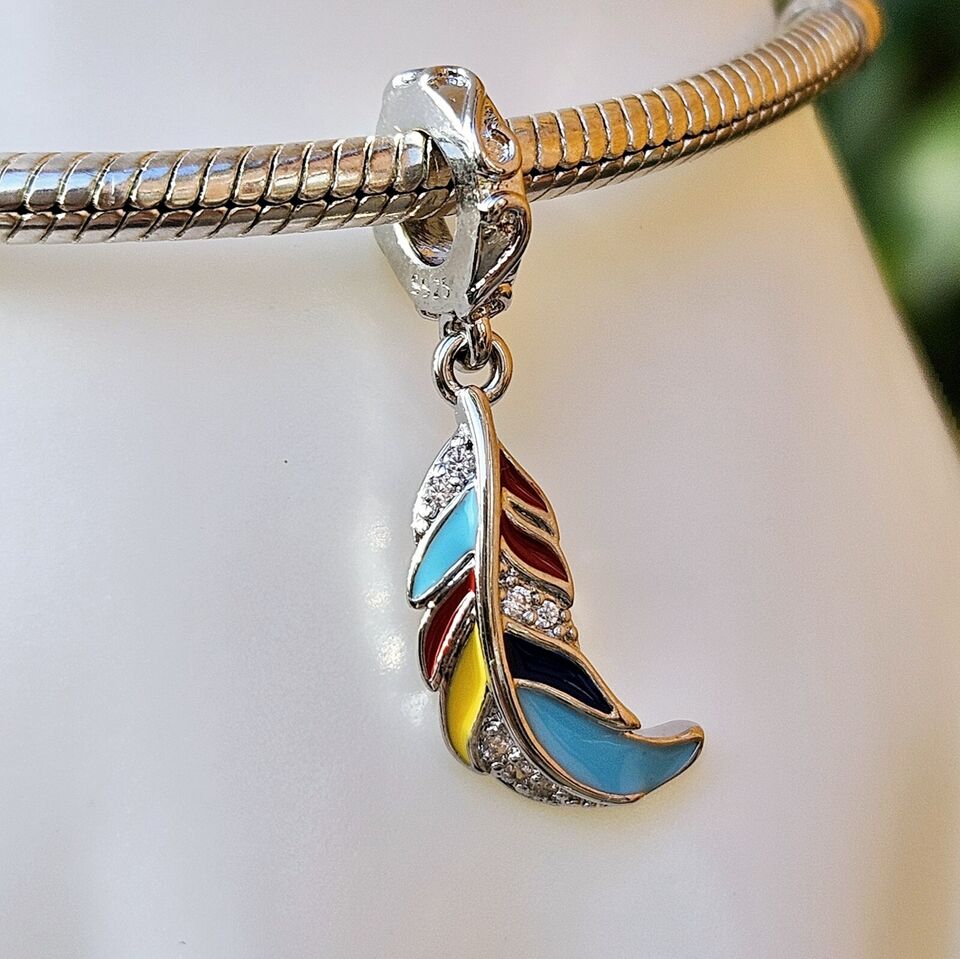 Multicoloured feather dangle charm with vibrant enamel detail