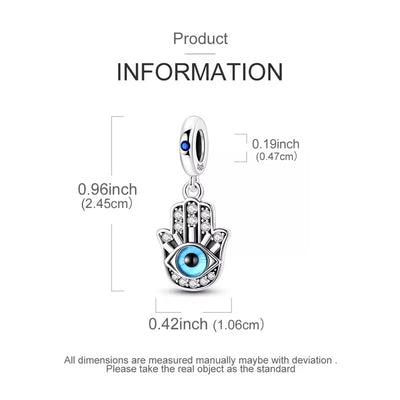 Silver Hamsa hand charm pendant with a blue eye and clear stones, shown with dimension labels on a white background.