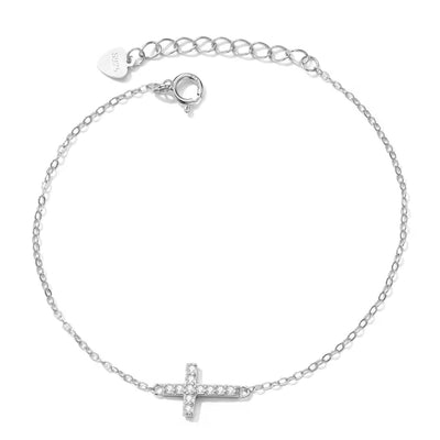 Dainty silver cross bracelet with sparkling crystals on wrist, minimalist adjustable chain jewelry