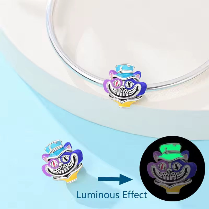 Silver grinning cat charm with purple blue and yellow enamel details and top hat