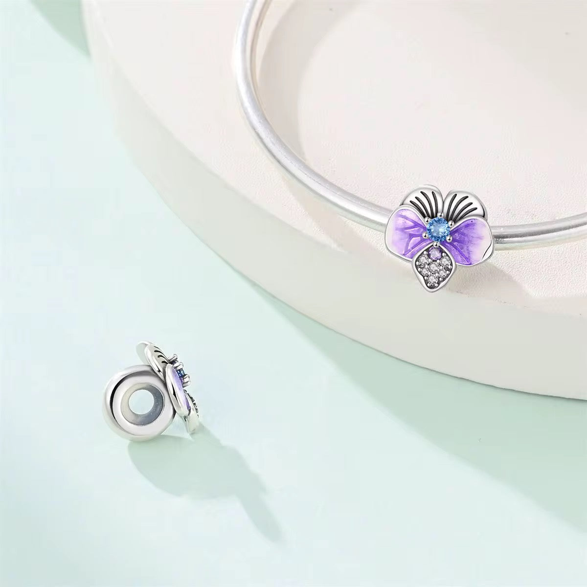 Silver butterfly charm with purple enamel wings and crystal details for charm bracelet