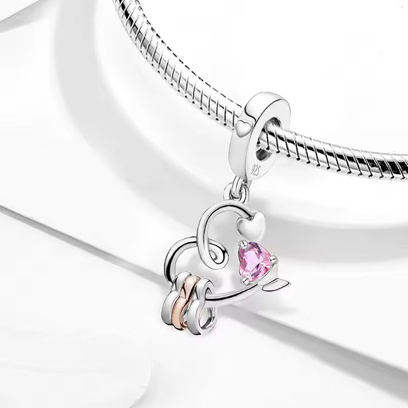 Silver heart charm with pink crystal and love knot detail elegant romantic jewelry charm for bracelet gift