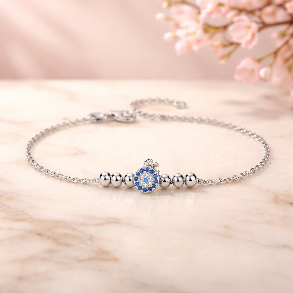Silver bracelet with a blue gemstone on a light wooden surface
