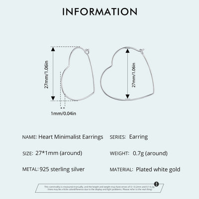 Minimalist heart-shaped hoop earrings in sterling silver worn on ear, thin elegant design