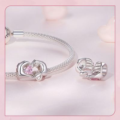 Silver charm with mother and child hands forming heart holding pink crystal bead for bracelet