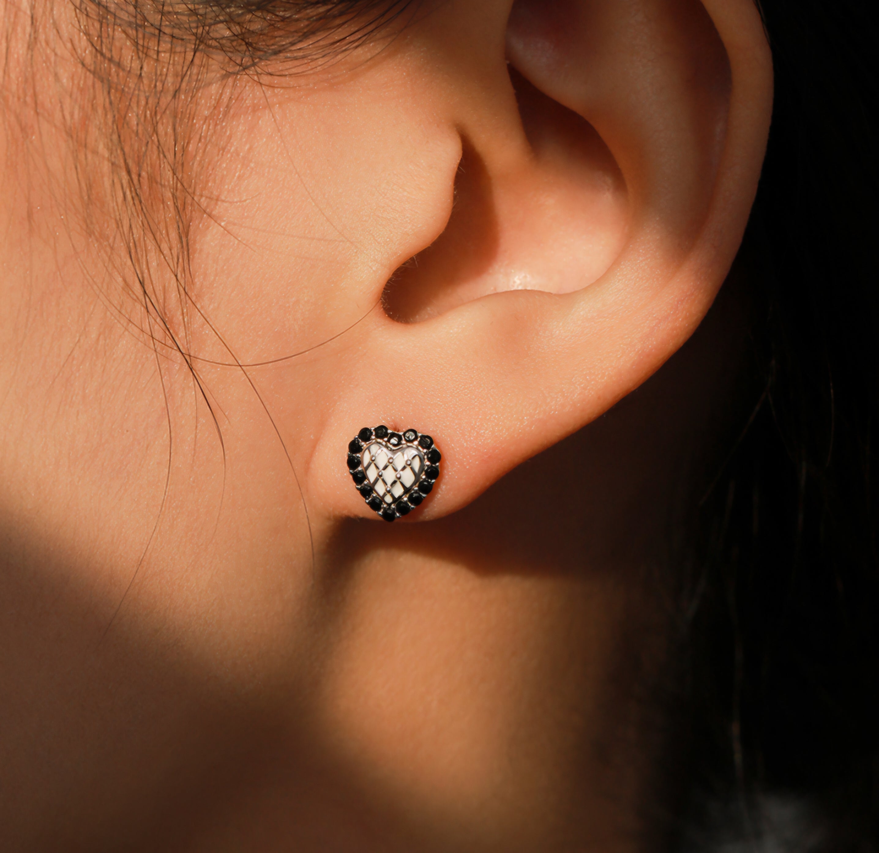 Silver heart stud earrings with black crystal border and white quilted center