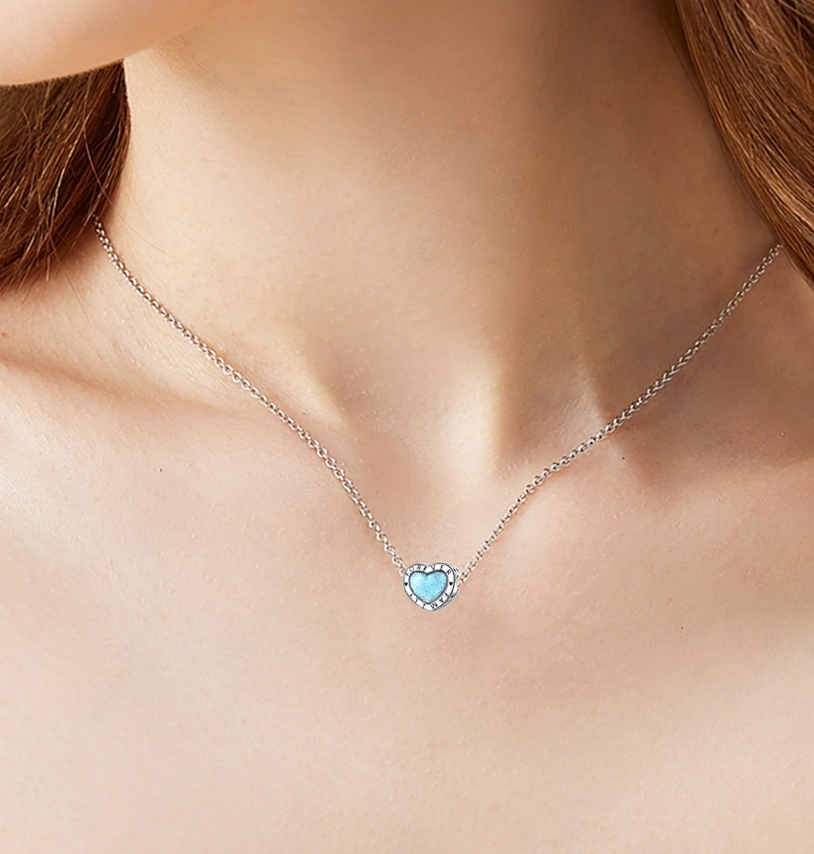Silver heart charm with blue glitter center engraved with Forever Family and small heart details