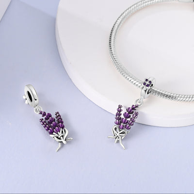 Sterling silver lavender flower dangle charm with purple enamel petals and crystal detail.