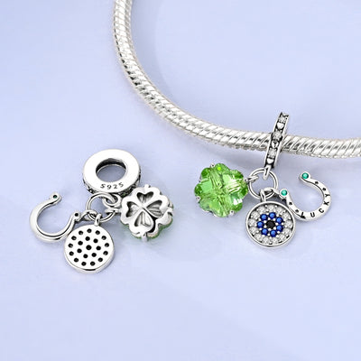 Sterling silver lucky charm with green crystal clover, evil eye pendant, and horseshoe detail