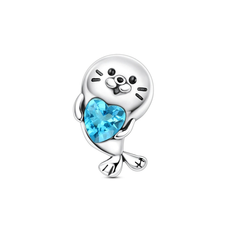 Silver seal charm holding a blue heart crystal pendant