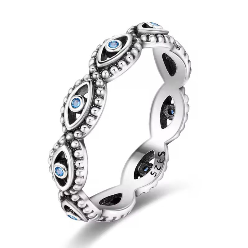 Sterling silver evil eye ring with blue crystal accents and beaded detailing