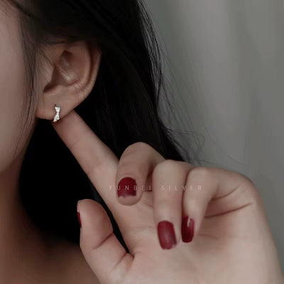 Sterling Silver Bow Huggie Earrings with Cubic Zirconia - bellissi