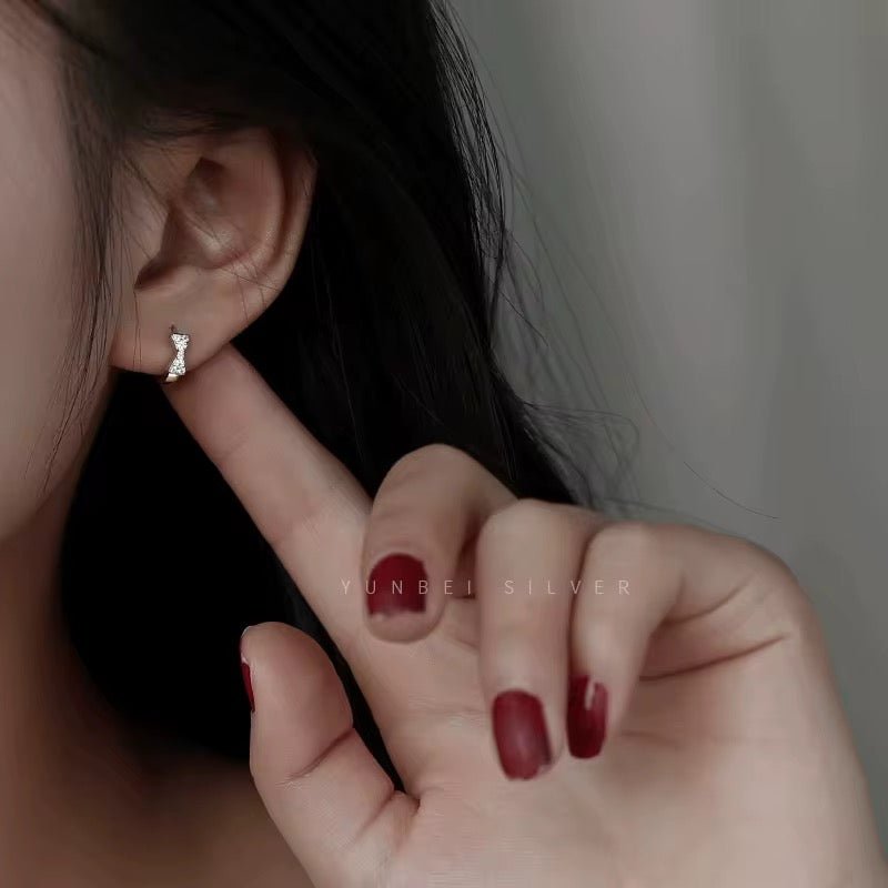 Sterling Silver Bow Huggie Earrings with Cubic Zirconia - bellissi