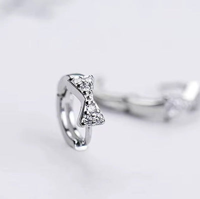 Sterling Silver Bow Huggie Earrings with Cubic Zirconia - bellissi